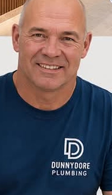 Dean Wheeler, owner and plumber at Dunnydore Plumbing, in a Dunnydore work shirt